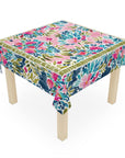 Table with a colorful floral tablecloth on a white background
