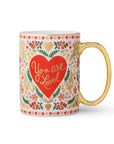 Mug with floral design and 'You are Loved' text on a white background