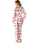 Person wearing a white onesie with red bow patterns on a white background