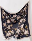 Decorative scarf with floral and gold chain pattern on a white background