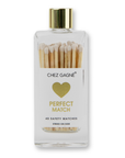 Bottle of matches with a gold cap and heart design on a white background