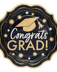 Graduation-themed paper plate with 'Congrats Grad!' text and decorative elements on a black background.