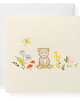 Card with a teddy bear and floral illustrations on a white background