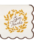 Decorative cocktail napkins with 'Give Thanks' text and gold leaves on a white background