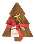 A Christmas-themed cutting board gift set featuring a triangular wooden cutting board shaped like a Christmas tree, decorated with a gold star topper, a red ribbon bow, and a hanging tag that reads 'Holiday CUTTING BOARD Giftset WITH SPREADER.'.
