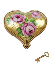 Heart-shaped decorative box with floral design and a key on a white background
