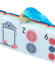 A decorative gift box designed to look like a Mahjong tile, featuring a white face with red and blue circular symbols, a black-and-white frame illustration, and a blue hanging ribbon with a gold ring.