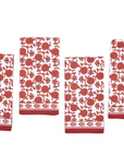 A set of four red and white floral patterned cloth napkins.
