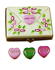 Decorative box with heart-shaped candies and 'For You' message, accompanied by three additional heart-shaped candies.