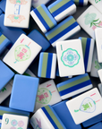 Close-up of a pile of blue and white Mahjong tiles.