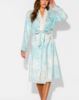 Woman wearing a light blue and white patterned robe on a white background
