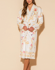 Woman wearing a floral robe against a beige background