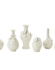 A set of six small ceramic vases in a warm off-white or cream color, decorated with raised floral and leaf motifs, arranged against a plain white background.