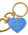 Gold and blue keychain with heart design on a white background