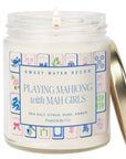 Candle in a jar with a decorative label featuring Mahjong design and brand name 'Sweet Water Decor'.