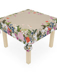Floral tablecloth on a wooden table with a white background