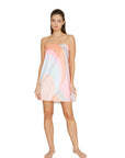 Woman wearing a strapless wrap with a colorful gradient pattern on a white background
