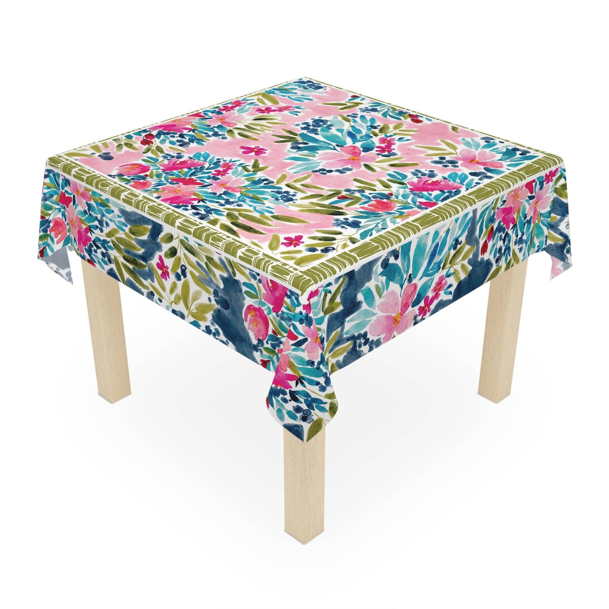 Table with a colorful floral tablecloth on a white background