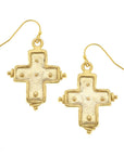Gold cross-shaped earrings on a white background