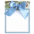 Notepad with a blue ribbon on a floral background