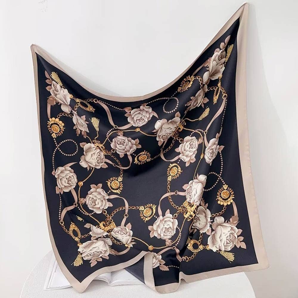 Decorative scarf with floral and gold chain pattern on a white background