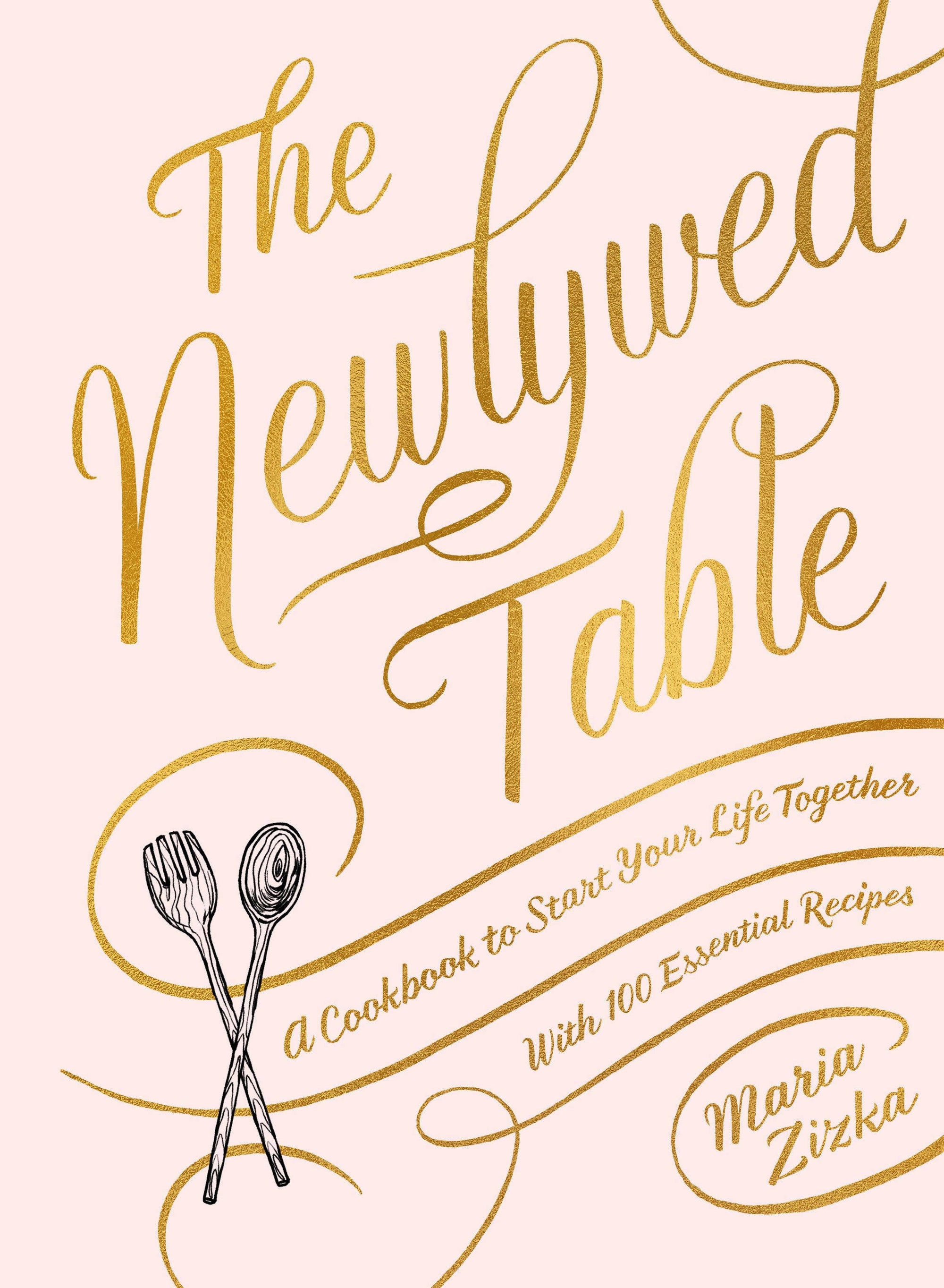 Book cover of 'The Newlywed Table' with gold text and utensils on a light pink background