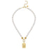 Pearl necklace with gold clasp and mahjong tile pendant on a white background