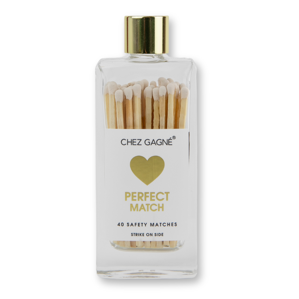 Bottle of matches with a gold cap and heart design on a white background
