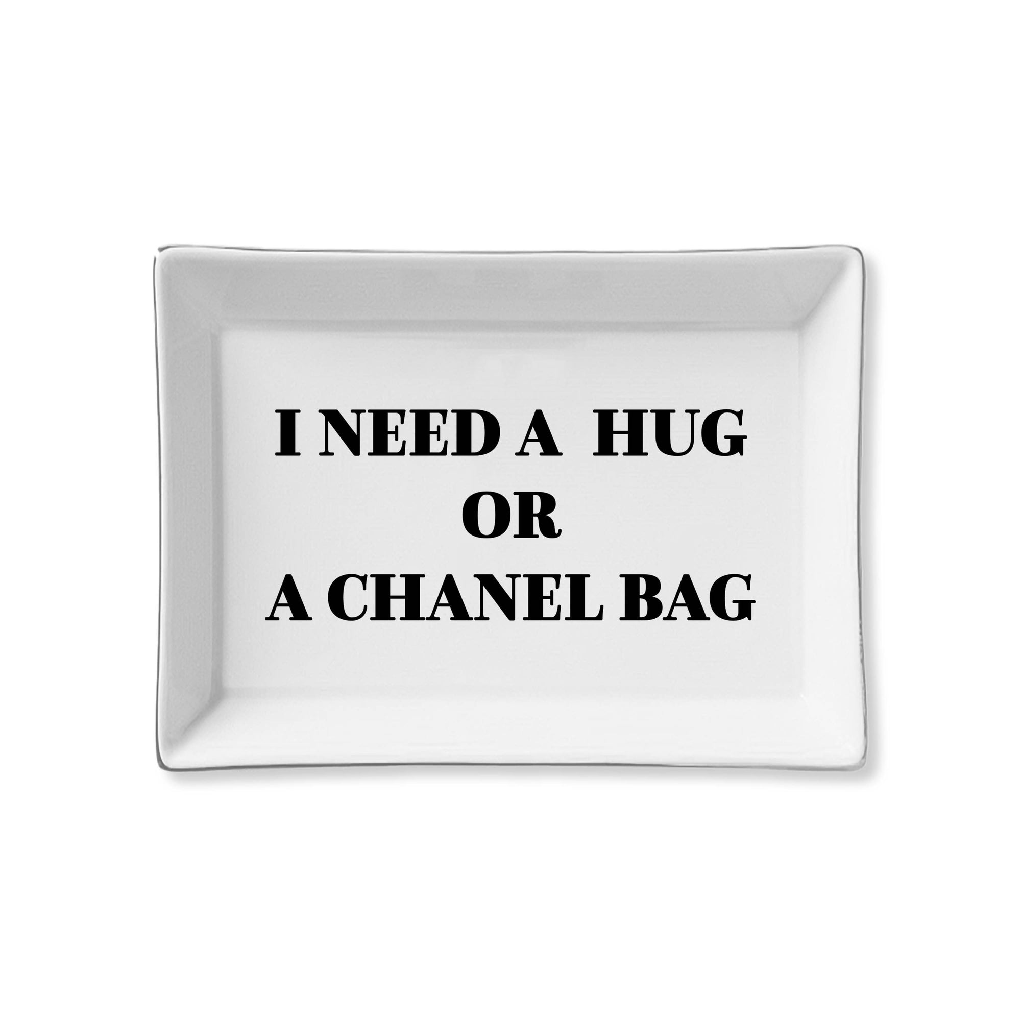 White tray with black text 'I NEED A HUG OR A CHANEL BAG' on a white background