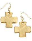 Gold cross-shaped earrings on a white background