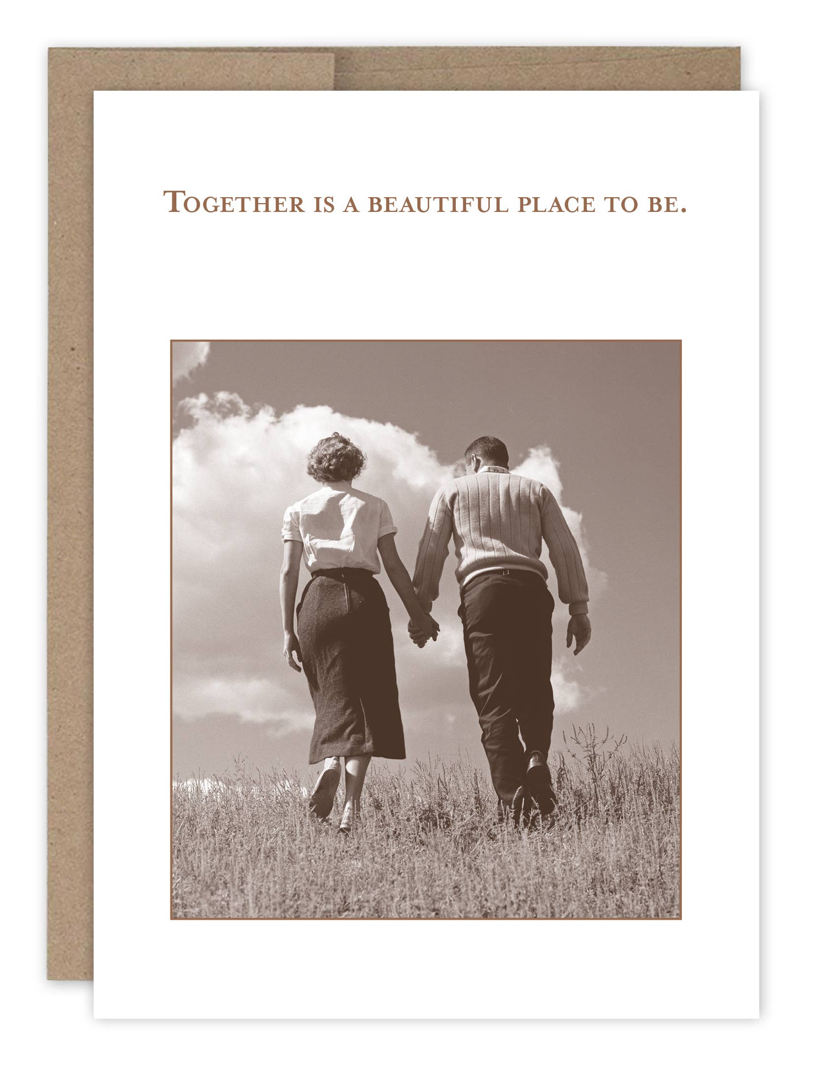 Greeting card with a black and white photo of two people holding hands in a field, with text 'Together is a beautiful place to be.'.