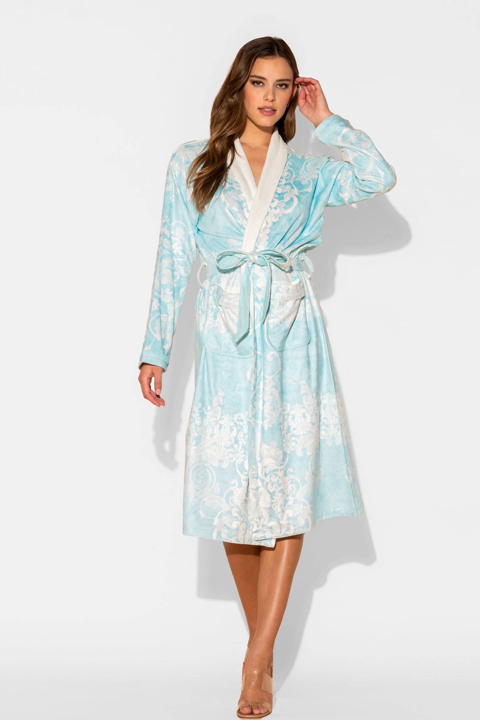 Woman wearing a light blue floral robe on a white background