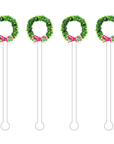 Four decorative cocktail sticks with green leafy ends and pink bows on a white background