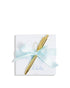 Gold pen with a light blue ribbon on a white card