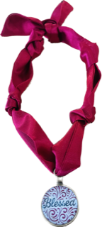 Red scarf with blessed pendant.