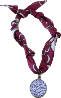 Necklace with fabric wrap and 'Blessed' pendant on a white background