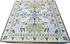 An ornate Mahjong mat with a detailed botanical and animal motif, featuring a light blue field, cream borders, green leaves, and blue accents.