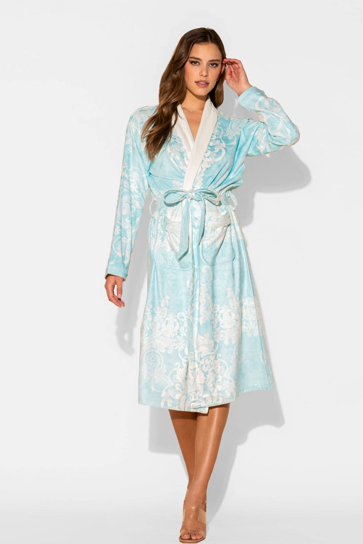 Woman wearing a light blue floral robe on a white background