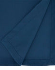 A close-up of a folded navy blue fabric item, showing the smooth texture and clean stitched border against a white background.