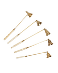 A collection of brass bell-shaped candle snuffers with antiqued gold finish and white handles.