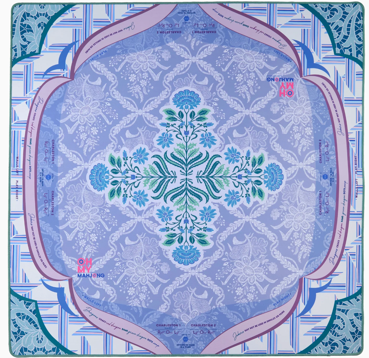 The Chantilly Mahjong Mat featuring an intricate mandala-style floral pattern in shades of blue, teal, and lavender, surrounded by a decorative border with script text and geometric accents.
