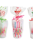 Three clear plastic cups with colorful text and designs, each tied with a ribbon on a white background.