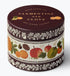 A round metal tin candle with a dark brown lid and a decorative label featuring illustrations of citrus fruits and botanical patterns, labeled 'CLEMENTINE AND GLOVE' by 'Belle Epoque Candles'.
