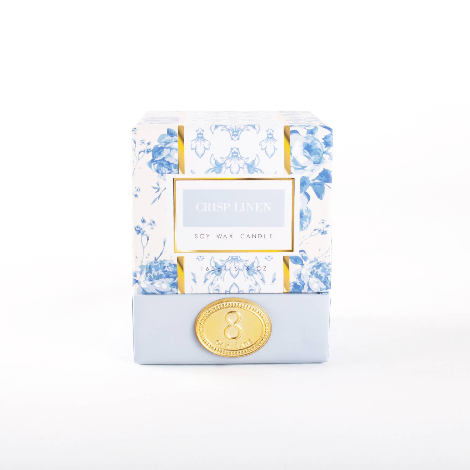 A Crisp Linen scented soy wax candle in a frosted glass container with a floral pattern and a gold-colored lid.