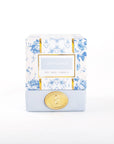 A Crisp Linen scented soy wax candle in a frosted glass container with a floral pattern and a gold-colored lid.