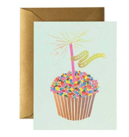Greeting card with a cupcake illustration and 'Happy Birthday' text, accompanied by a brown envelope.