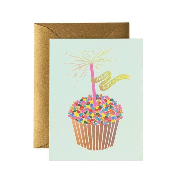 Greeting card with a cupcake illustration and 'Happy Birthday' text, accompanied by a brown envelope.