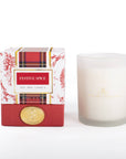 A 'Festive Spice' soy wax candle shown next to its retail packaging box. The candle is in a frosted glass jar with gold branding, and the box features a red and white plaid pattern with red floral accents and a gold seal.