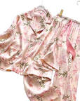 Floral pajama set with a pink ribbon on a light background