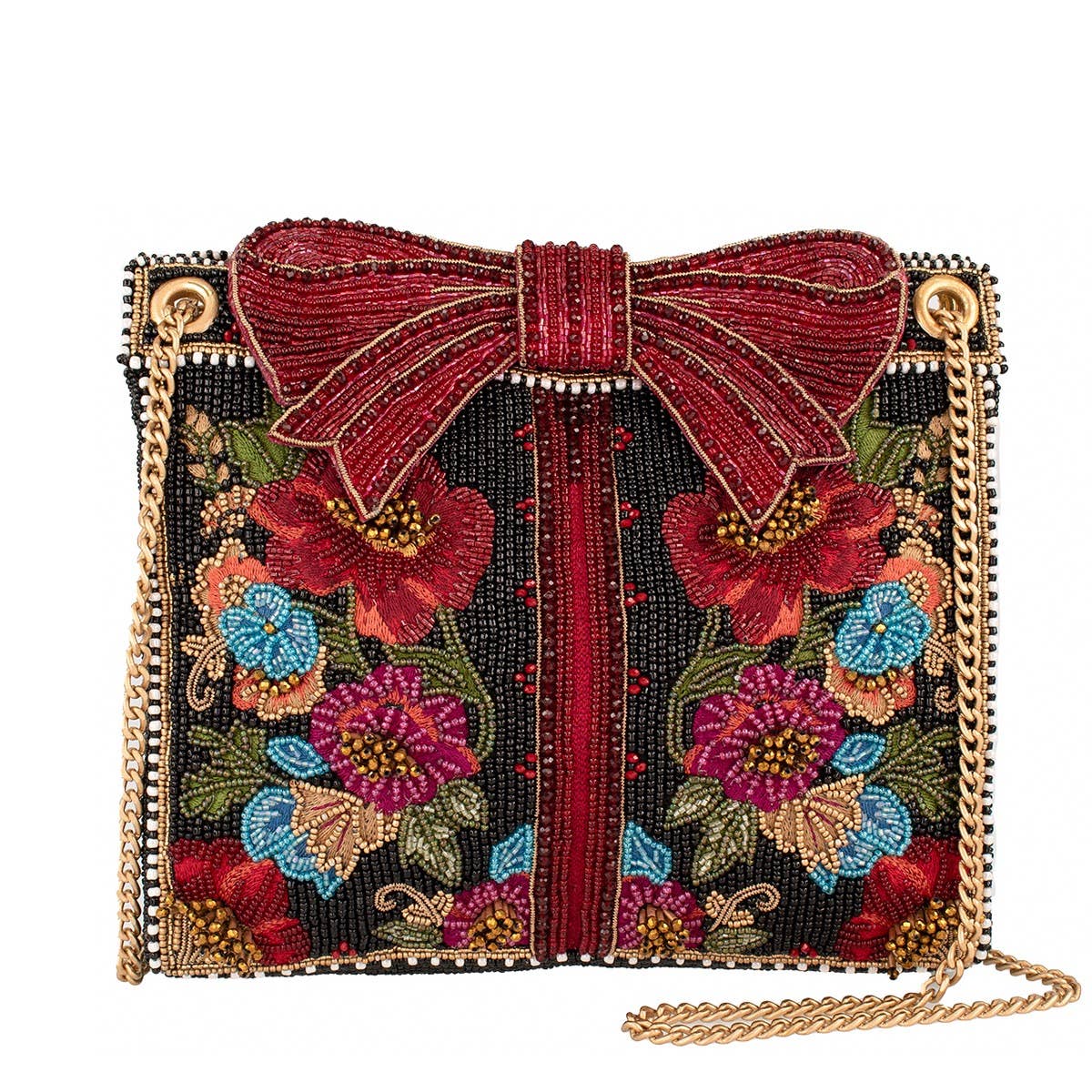 A square beaded clutch bag featuring a large red beaded bow on top, a black beaded background with colorful floral embroidery in red, blue, pink, and green, and gold-tone chain strap details.